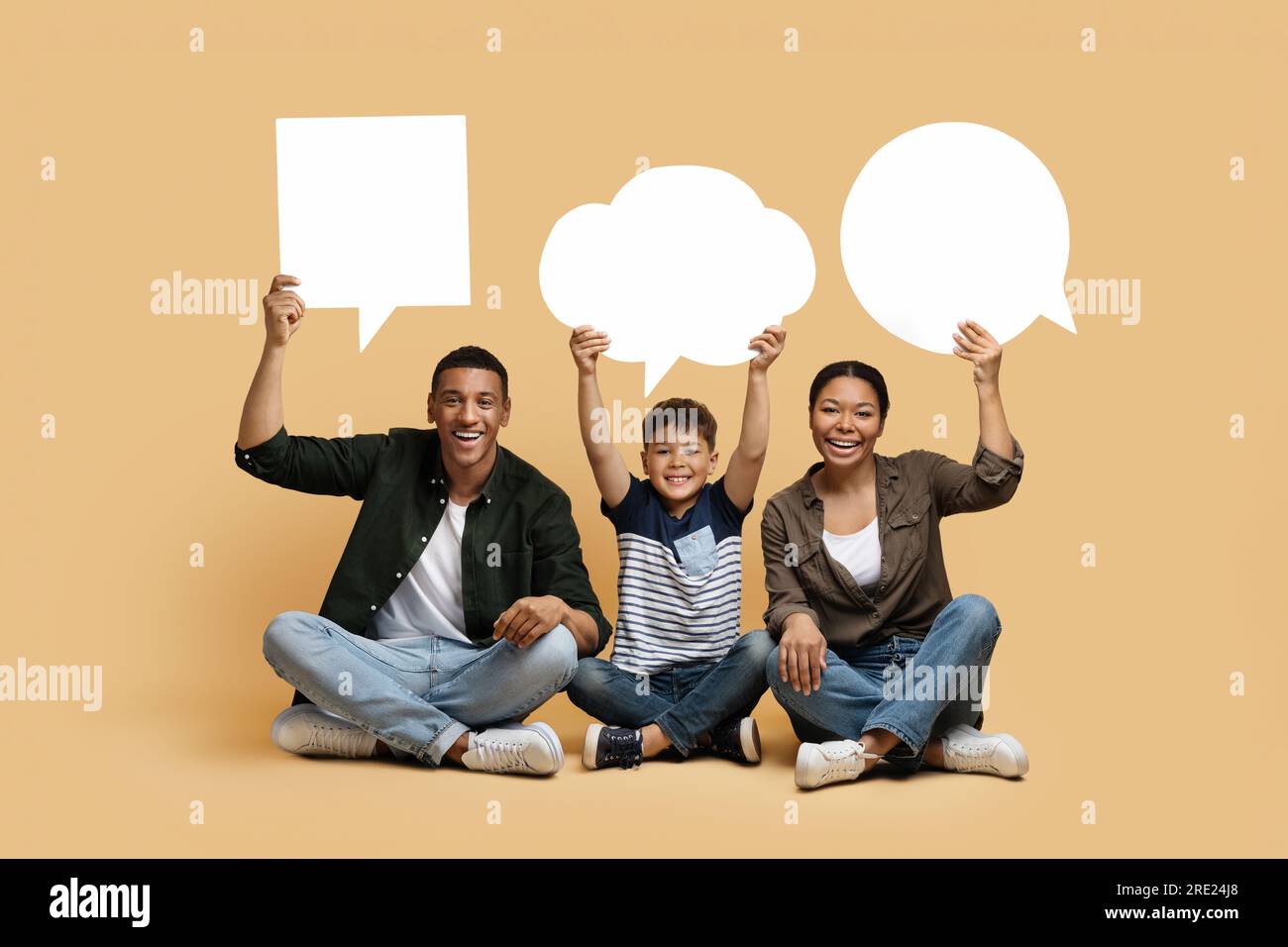 Black mom, dad and son holding different empty speech bubbles Stock Photo