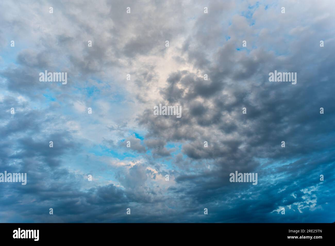 Incredibly beautiful clouds with a blue gap. Evening sky after the rain. Stock Photo