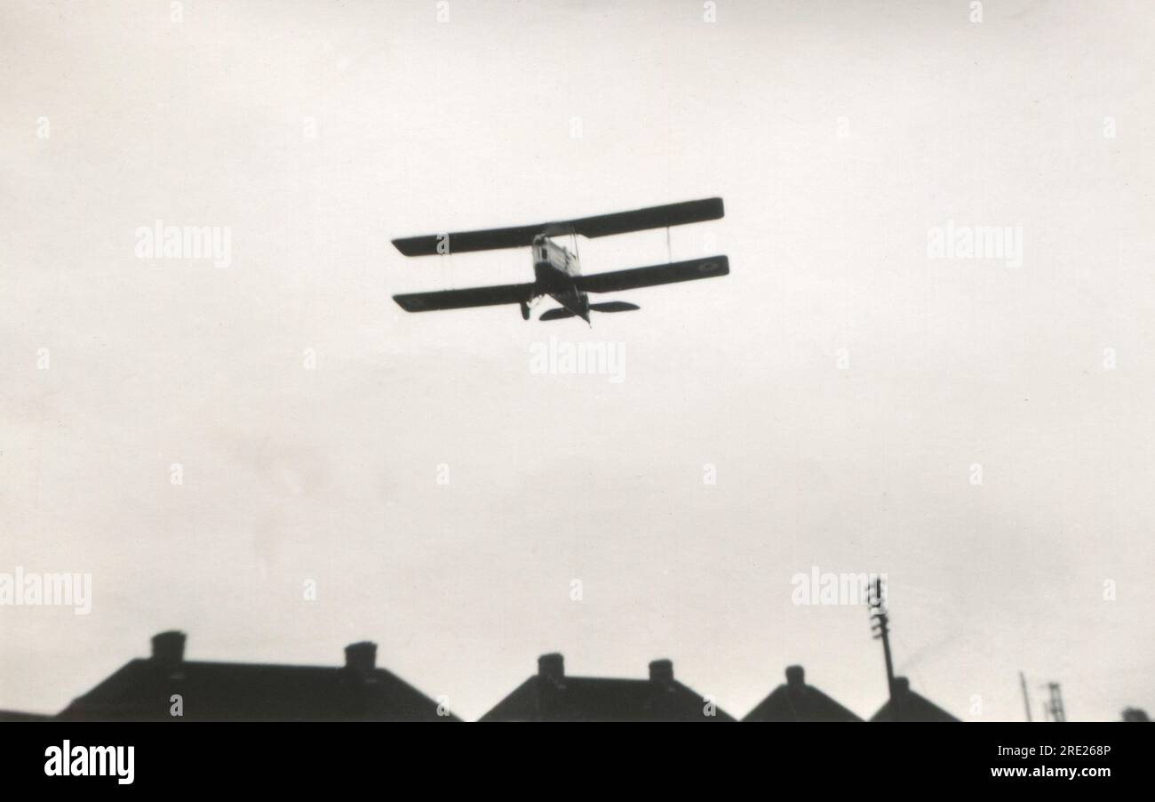 Brough, East Yorkshire. c.1938 – A Royal Air Force Blackburn B-2 trainer biplane of No.4 Elementary and Reserve Flying Training School descending over rooftops, coming into land at Brough Aerodrome. Stock Photo