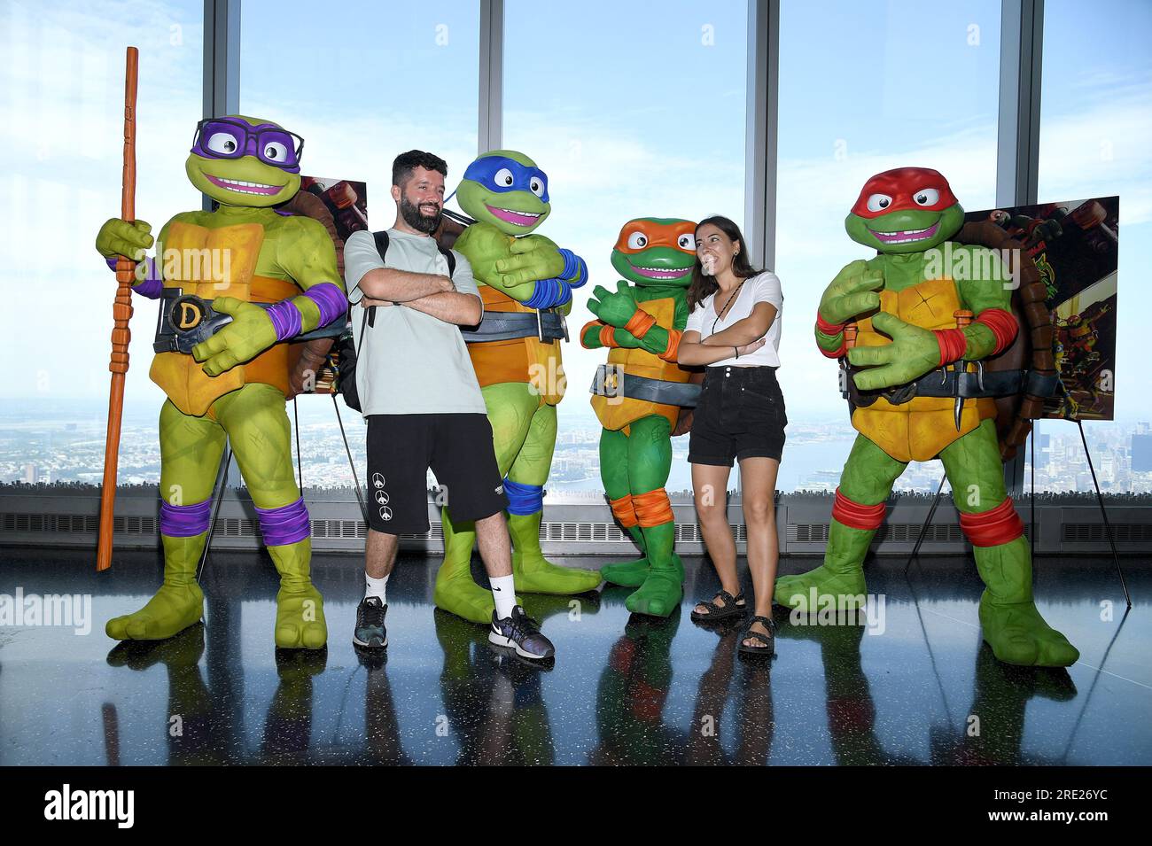 New York, USA. 24th July, 2023. Visitors pose with comic book and movie ...