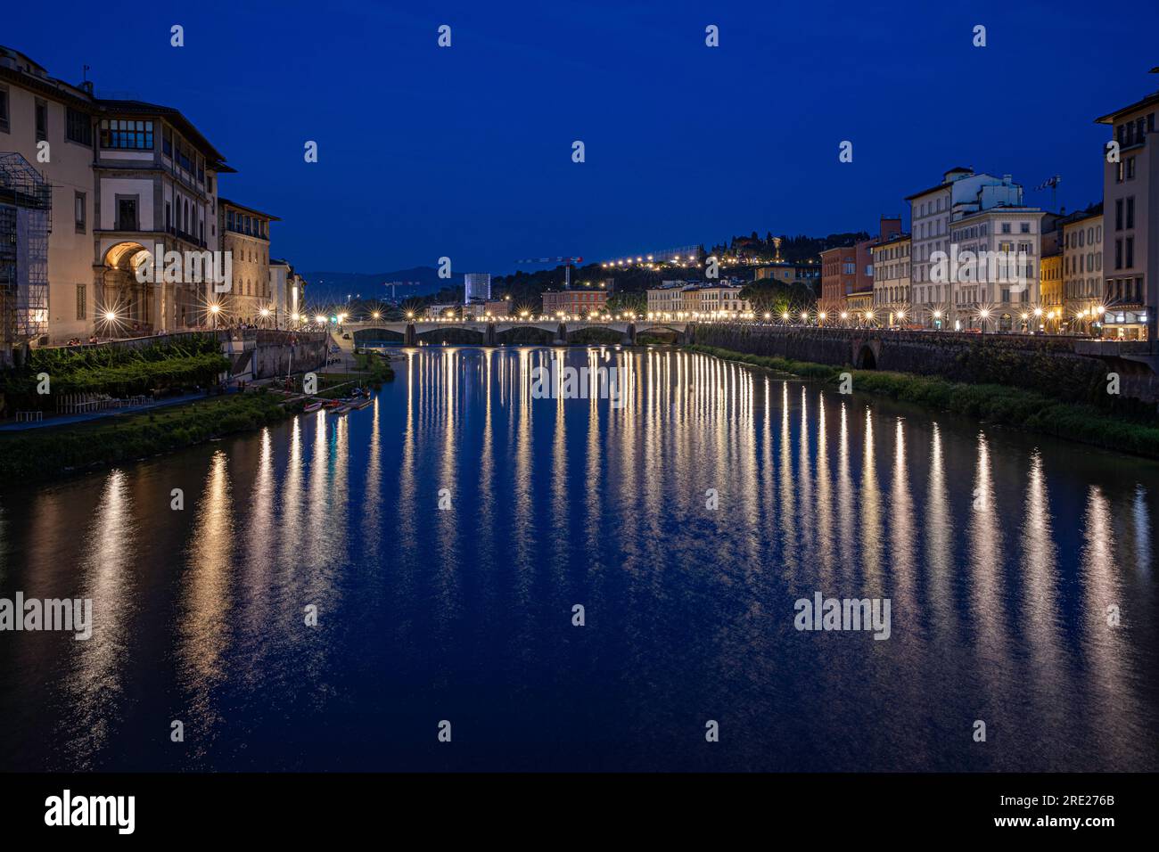 View from the Ponte Veccio in Florence, Italy of the river Arno in the blue hour. Reflection of the lighting. Stock Photo