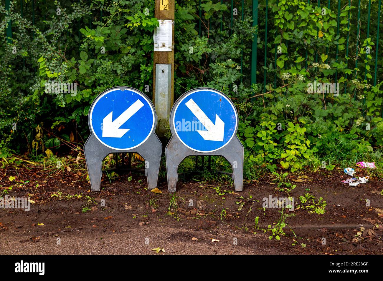 traffic direction sign blue circle with white direction arrow pointing ...
