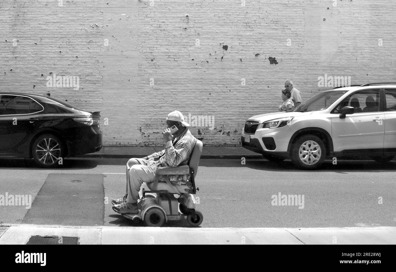 A man rides a batterypowered electric power chair or wheelchair along