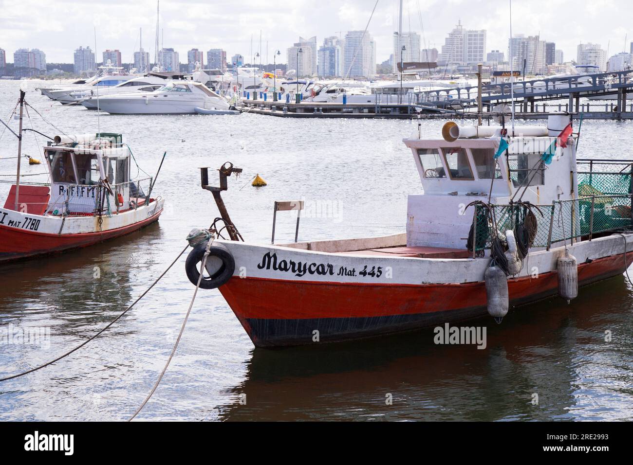 Serene fishing boats docked at the pier in Punta del Este, Uruguay, capturing the tranquility of the coastal town Stock Photo