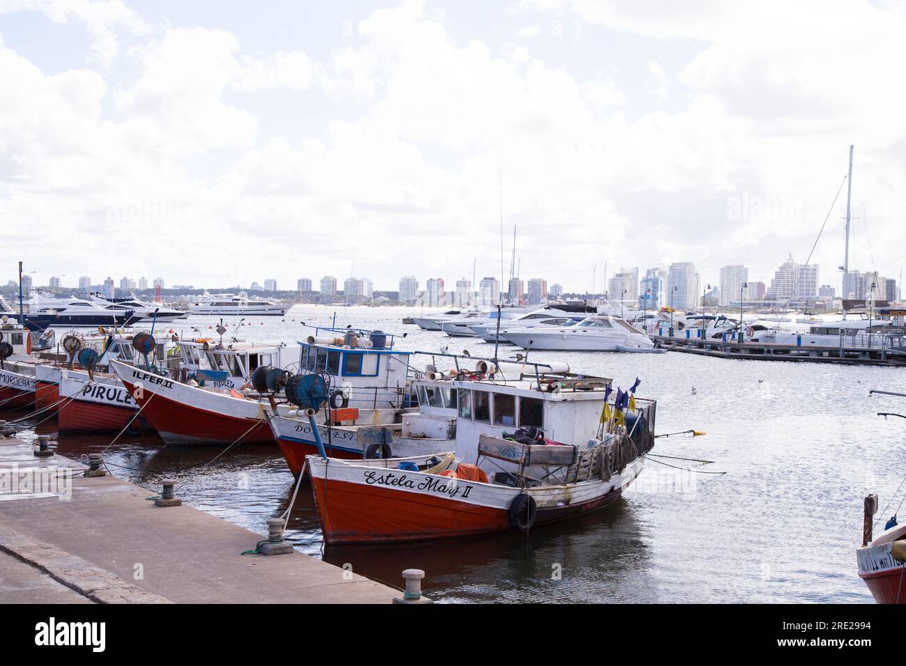 Serene fishing boats docked at the pier in Punta del Este, Uruguay, capturing the tranquility of the coastal town Stock Photo