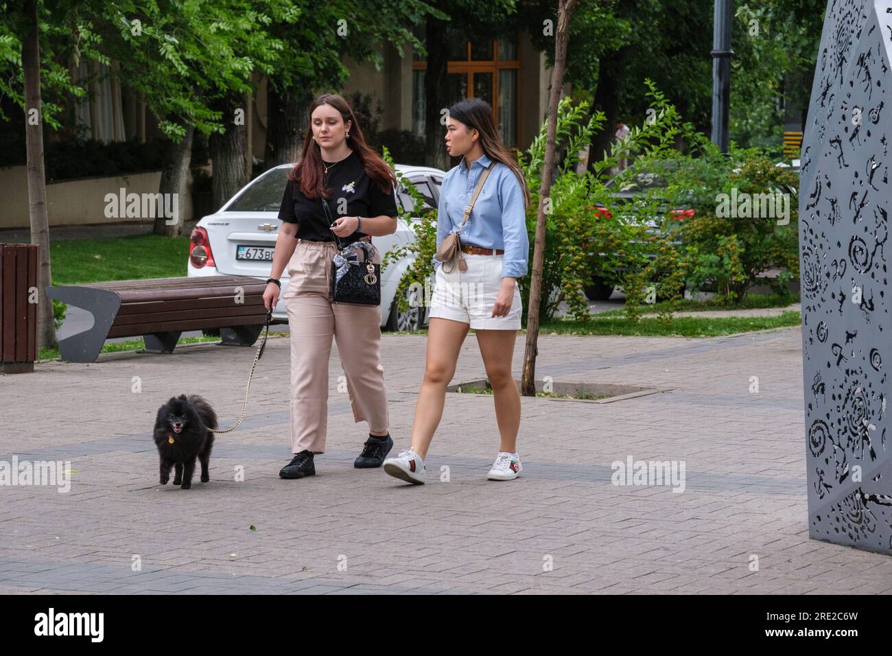 Kazakhstan, Almaty. Women Walking on the Panfilov Promenade, a Pedestrian Walkway. Stock Photo