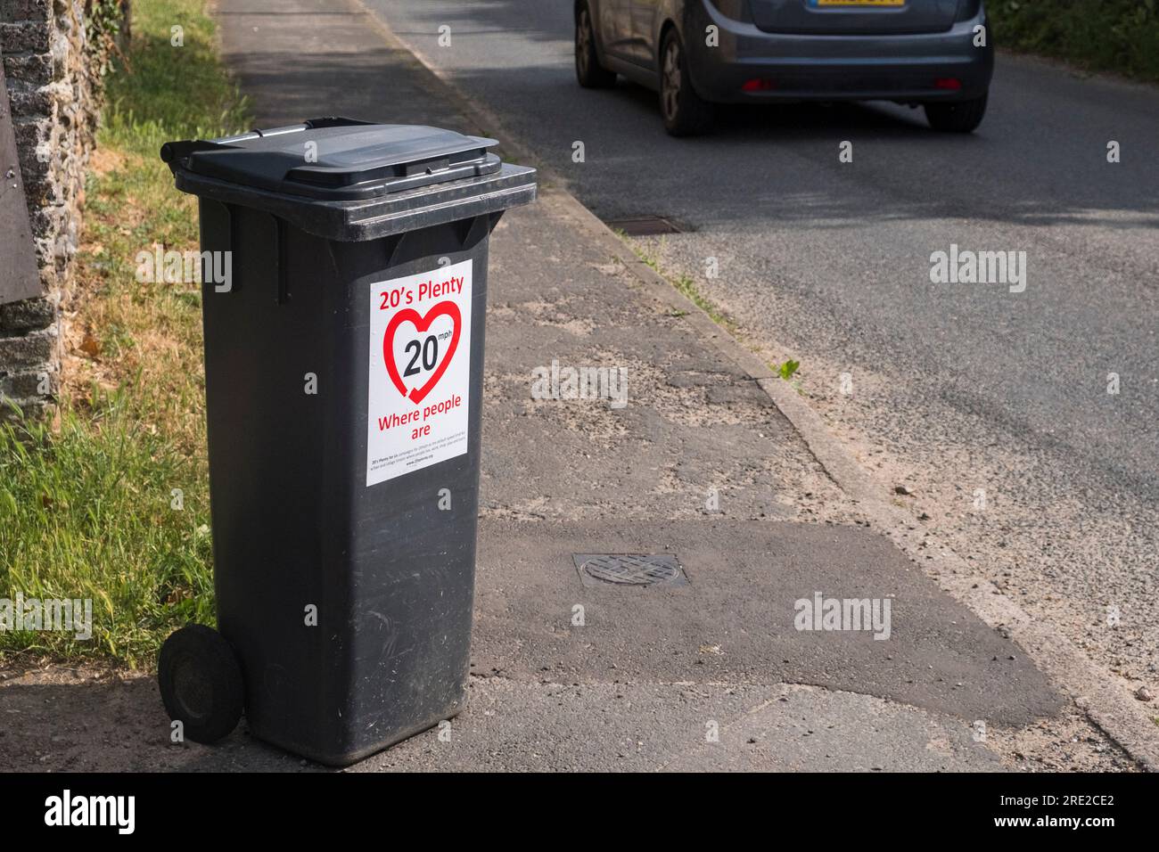 '20's plenty where people are' sign on a fefuse bin at the side of a Suffolk, UK village roadside. Stock Photo
