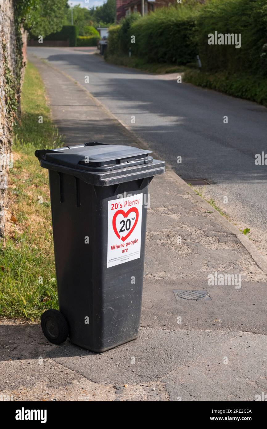 '20's plenty where people are' sign on a refuse bin at the side of a Suffolk, UK village roadside. Stock Photo