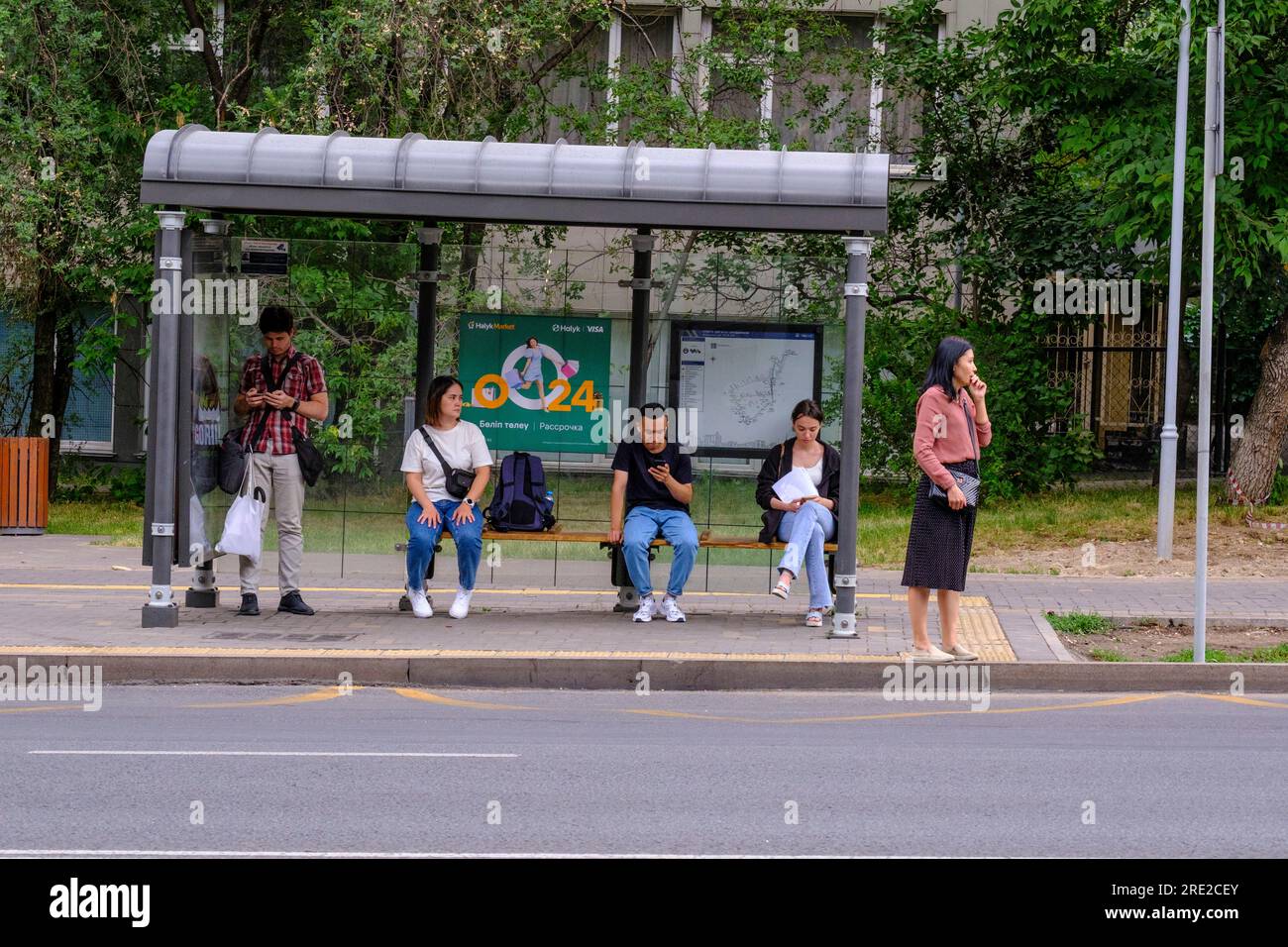 Kazakhstan, Almaty. Street Scene Passengers Waiting for Bus at Bus