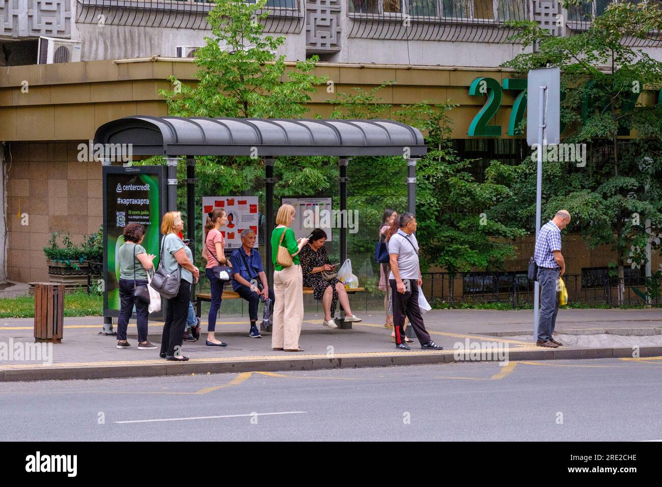 Kazakhstan, Almaty. Street Scene Passengers Waiting for Bus at Bus
