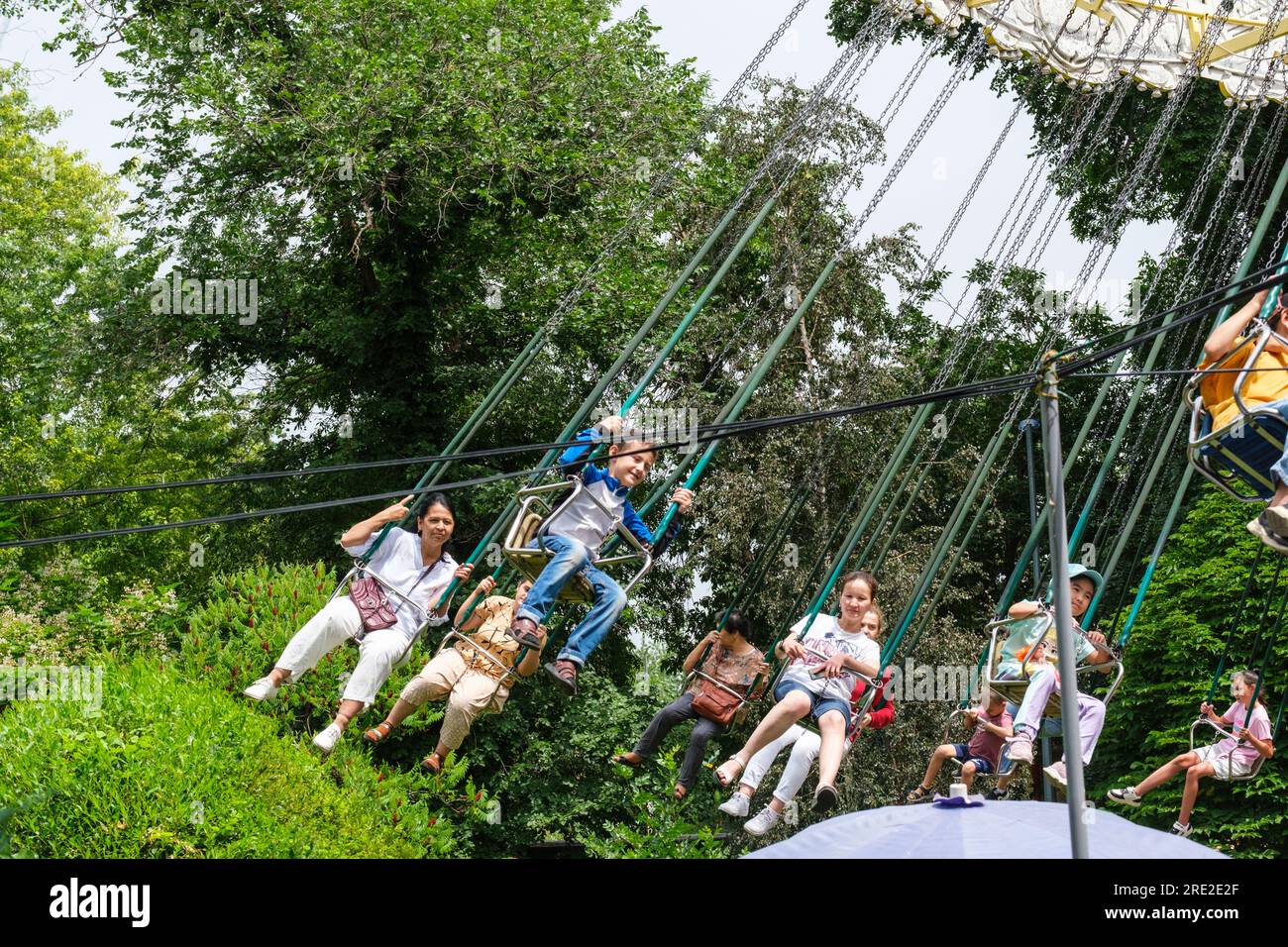 Kazakhstan, Almaty. People on Amusement Park Ride, Central Park for Culture and Recreation. Stock Photo