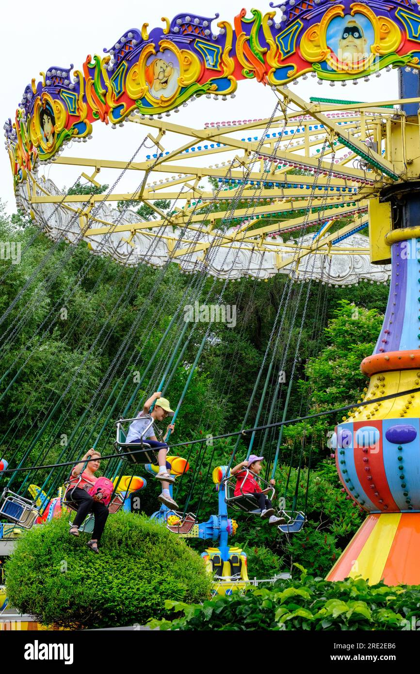 Kazakhstan, Almaty. People on Amusement Park Ride, Central Park for Culture and Recreation. Stock Photo