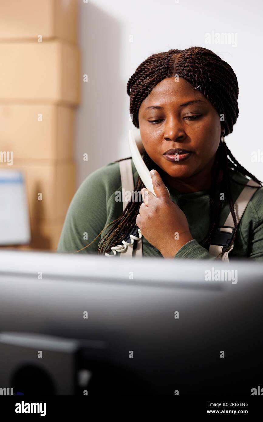 Stockroom supervisor discussing order delivery details with remote