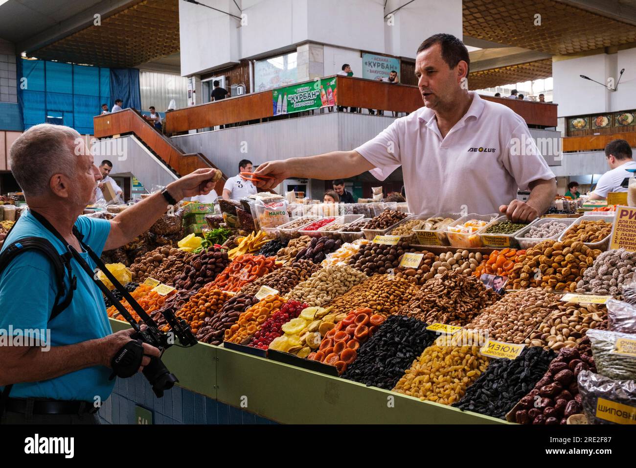 Kazakhstan, Almaty. Vendor of Nuts and Dried Fruits in the Green Bazaar. Stock Photo