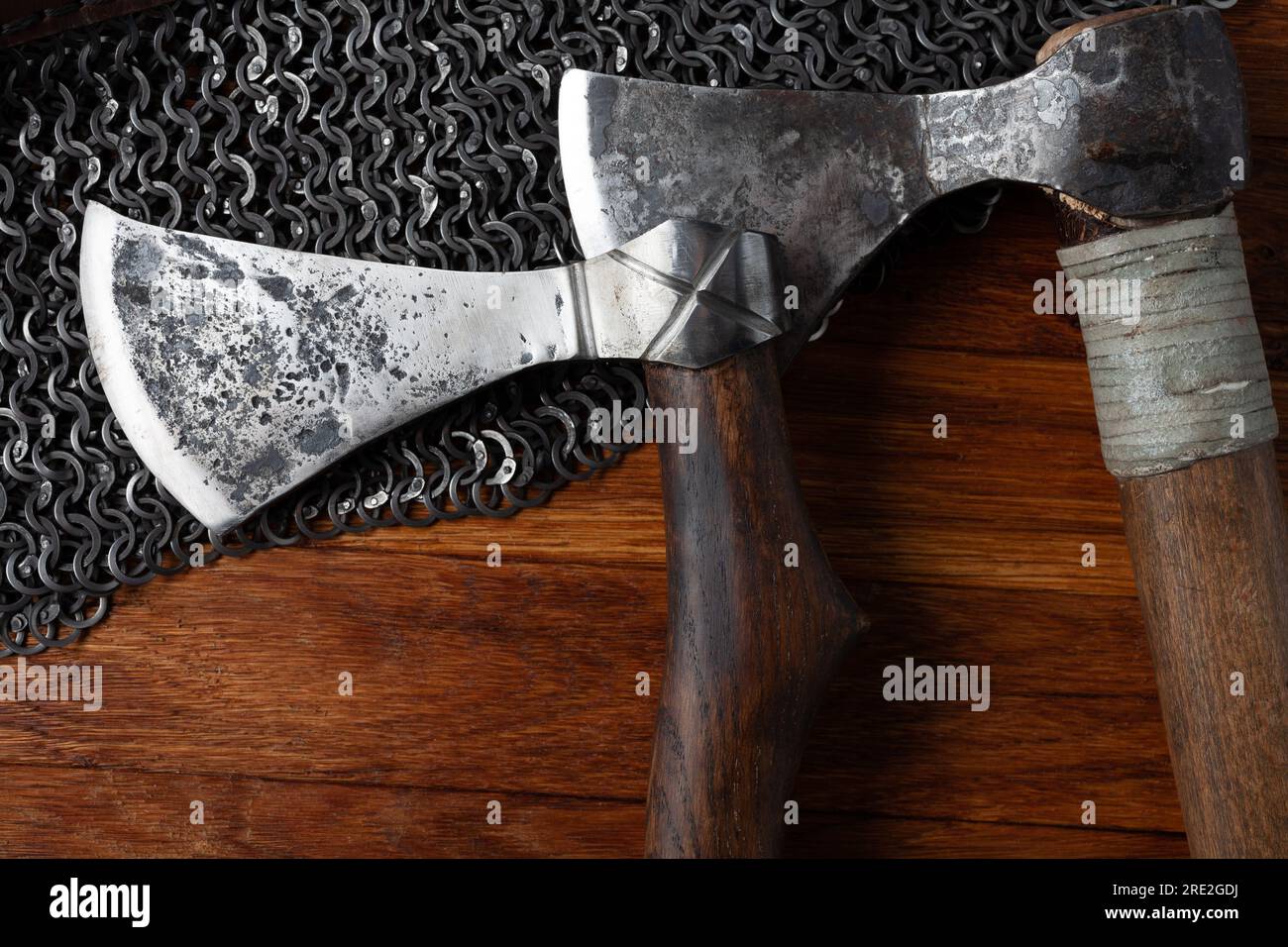 Medieval battle axes on chain mail armor background Stock Photo Alamy