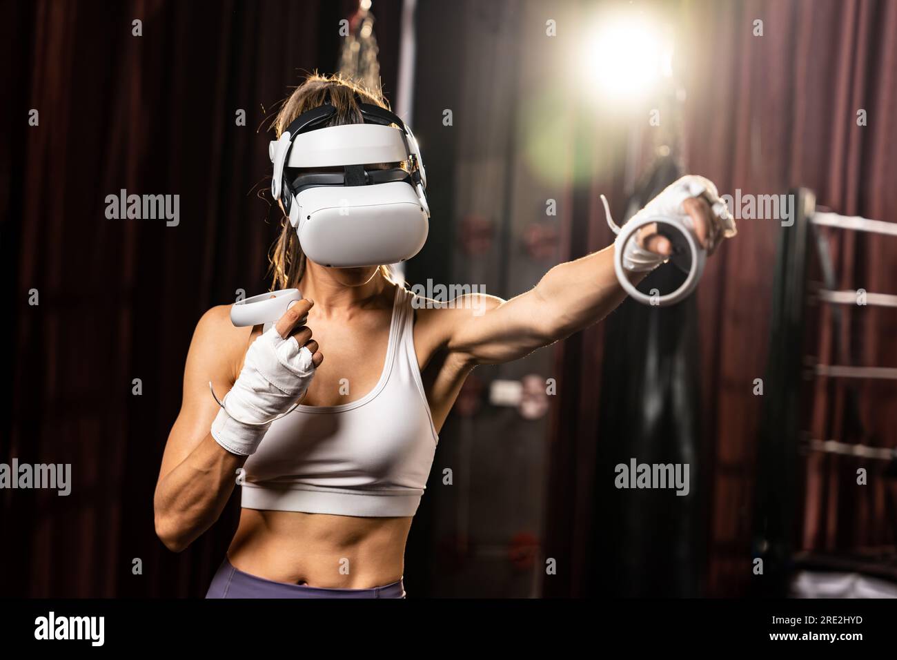 Female boxer training with VR or virtual reality, wearing VR headset