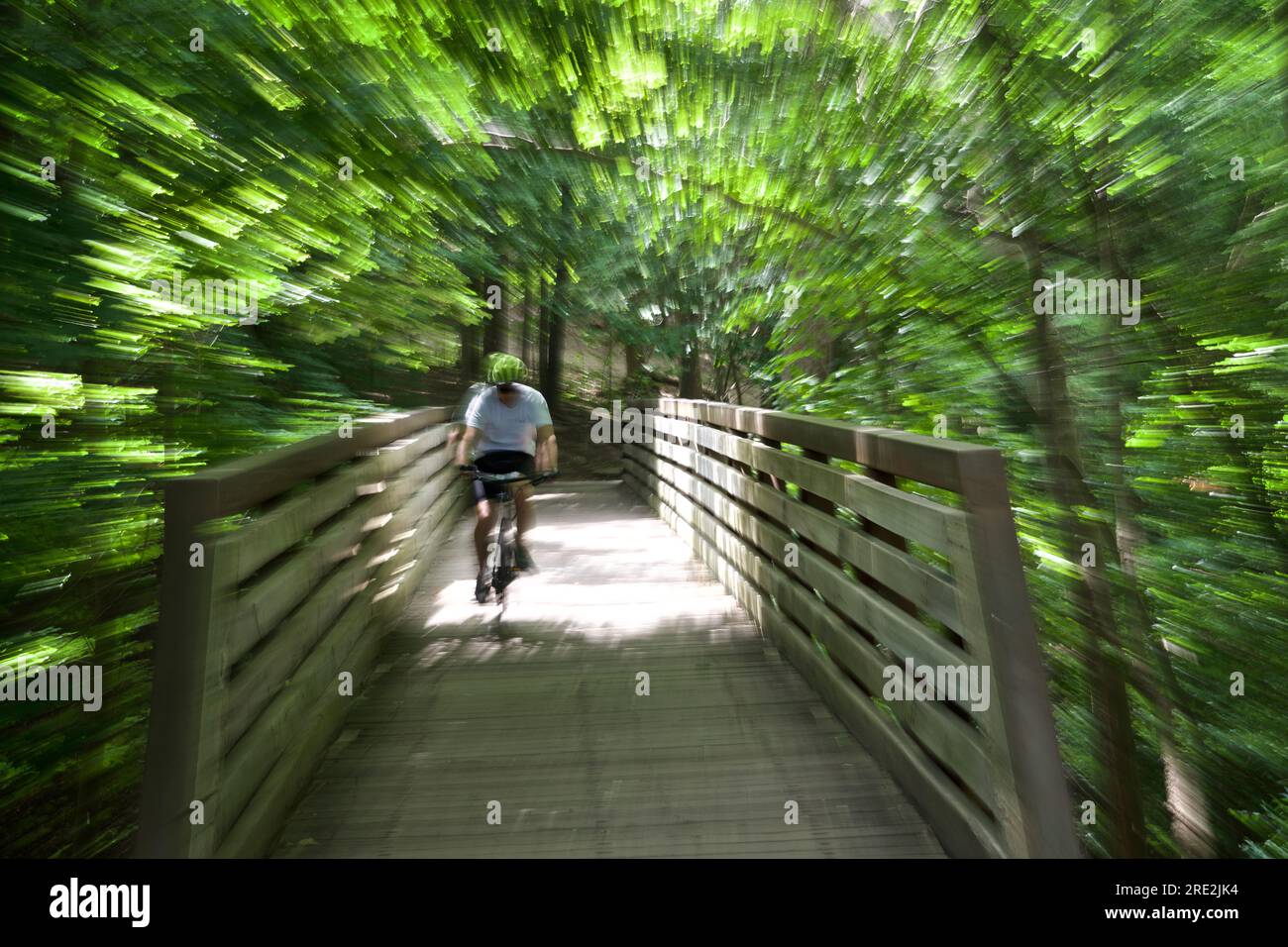 Blurred motion of riding bicycle when crossing the bridge, Stock Photo