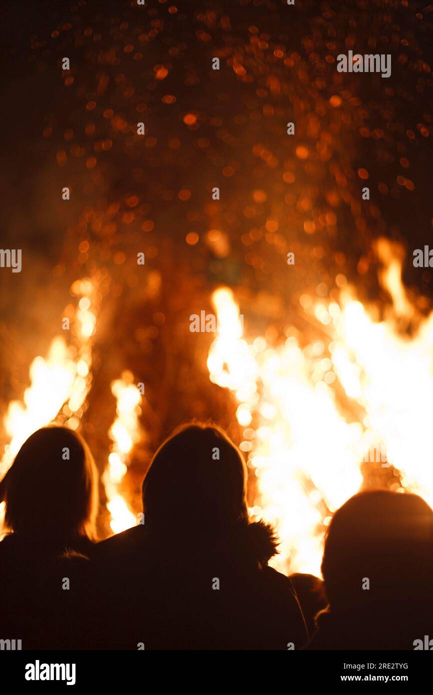 People stand around a bonfire on Guy Fawkes night in England, UK Stock Photo