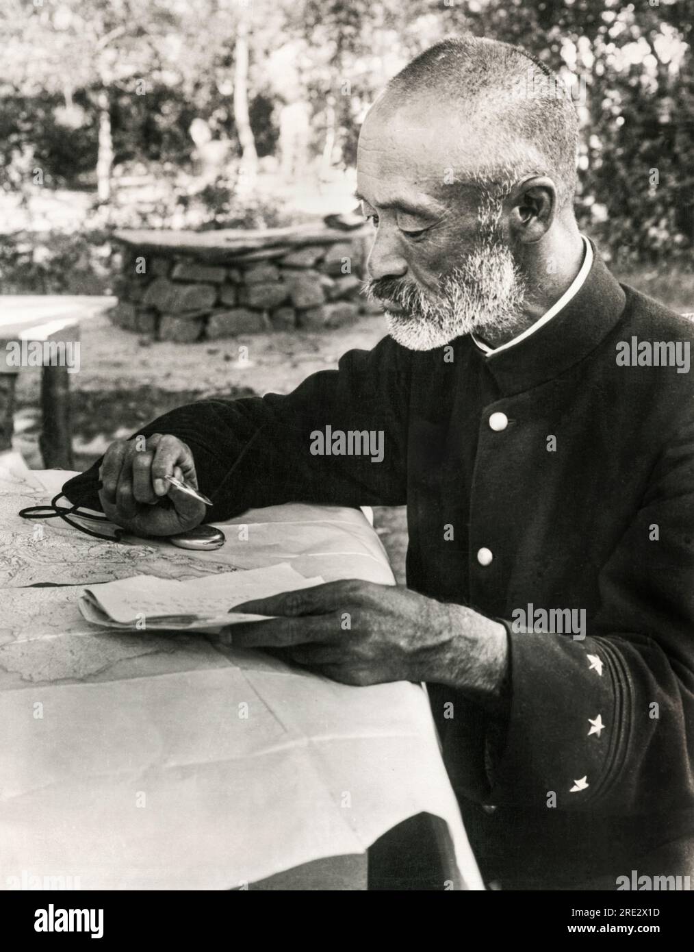 Port Arthur, Manchuria:  September 13, 1904 Japanese General Nogi Maresuke studying his seige map at his headquaters during the Russo-Japanese War. Stock Photo