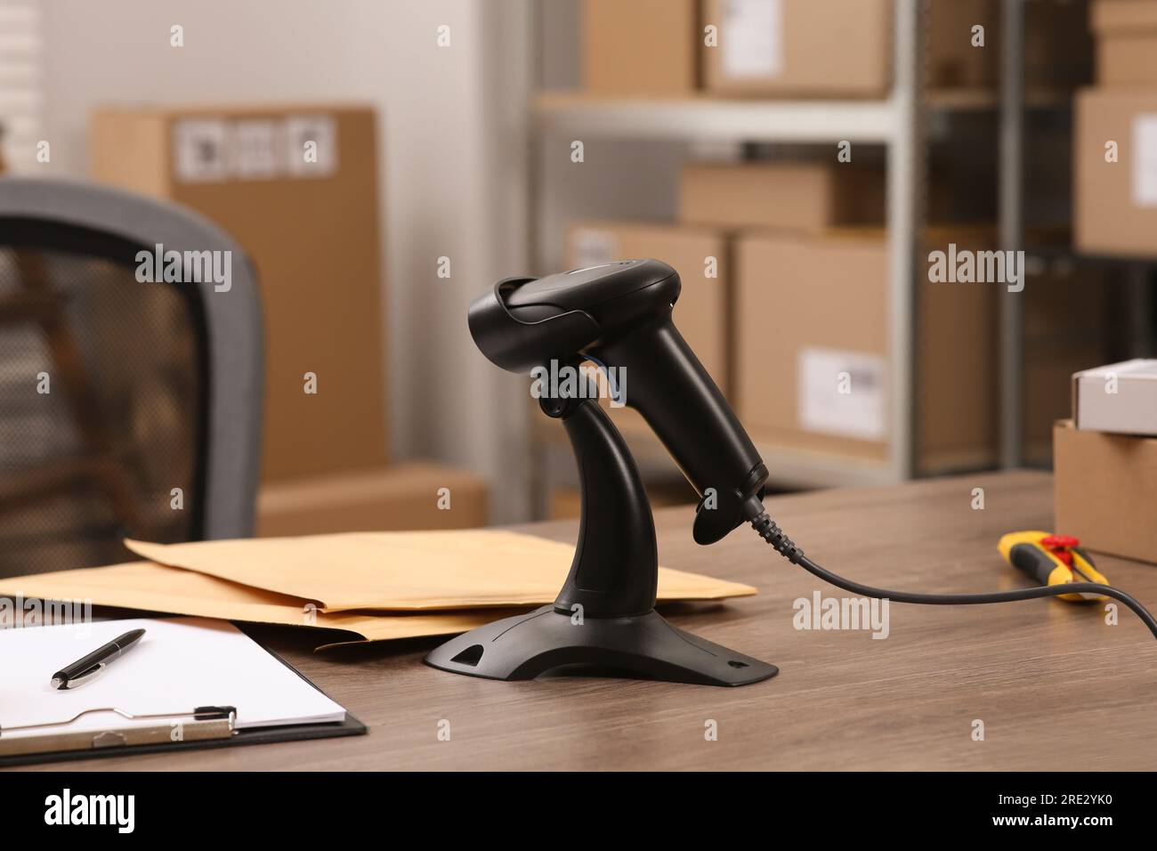 Black modern barcode scanner on wooden table in office. Online store ...