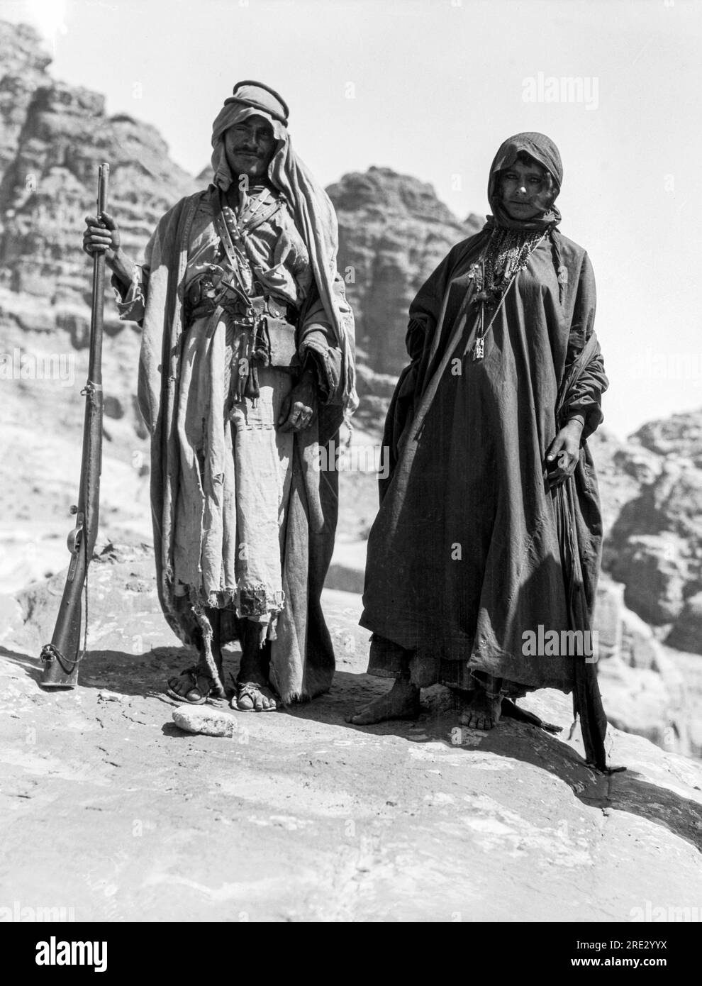 Jordan:  c. 1924  A Bedouin of the Bdul tribe of Petra and his pregnant wife. Stock Photo