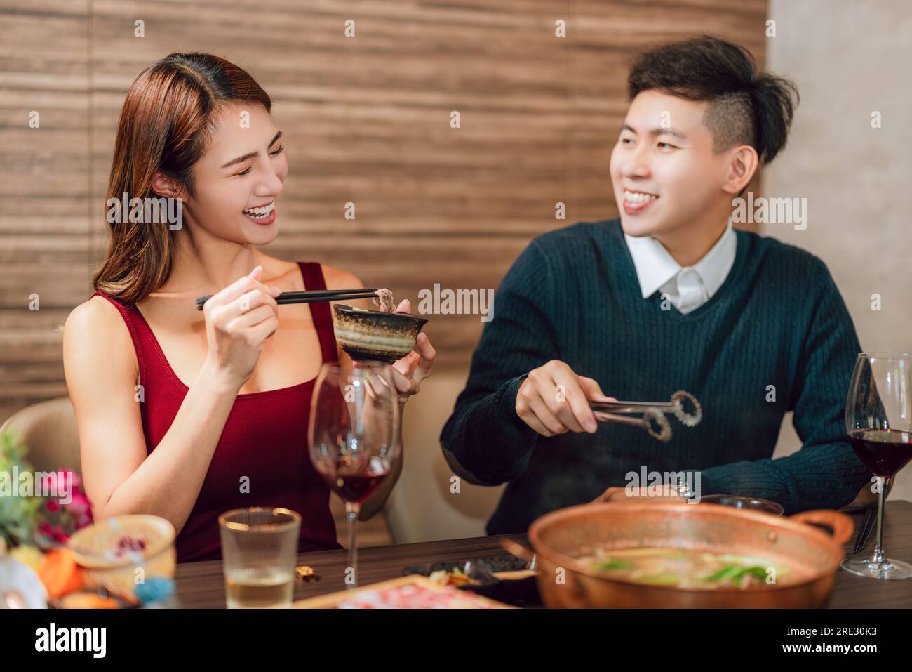 Happy couple dining in hotpots restaurant Stock Photo