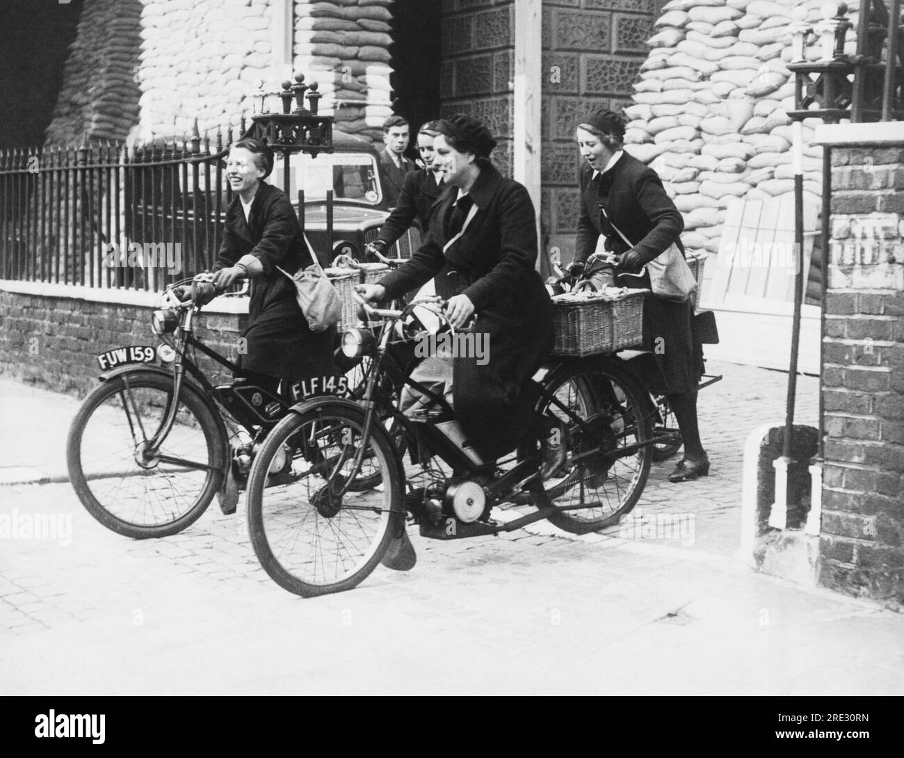 London, England:  September 25, 1939 Queen Charlotte's Hospital nurses have formed a motorcycle squad and here are some of them heading out on their rounds. Stock Photo