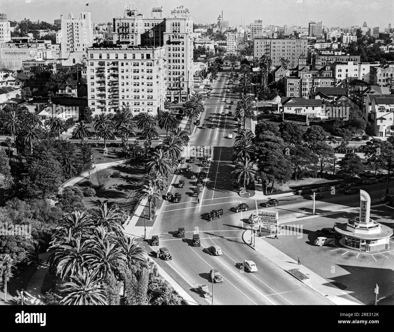 Los Angeles, California:  c. 1939. Looking east on Wilshire Blvd. at Hoover St. with Simon's Drive-In in the lower right and the Arcady Hotel a couple of blocks up on the left. Stock Photo