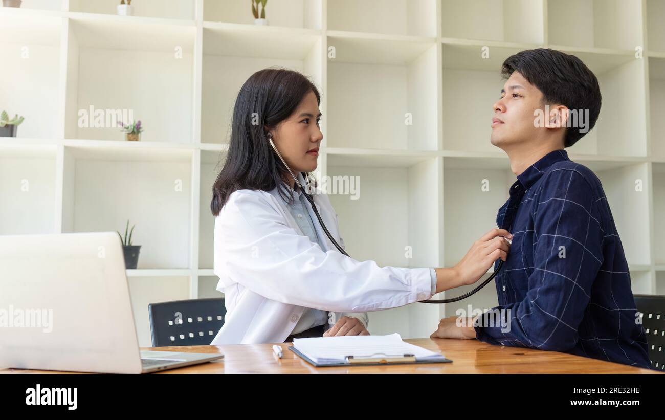 Female doctor using stethoscope listening patients heart Stock Photo ...