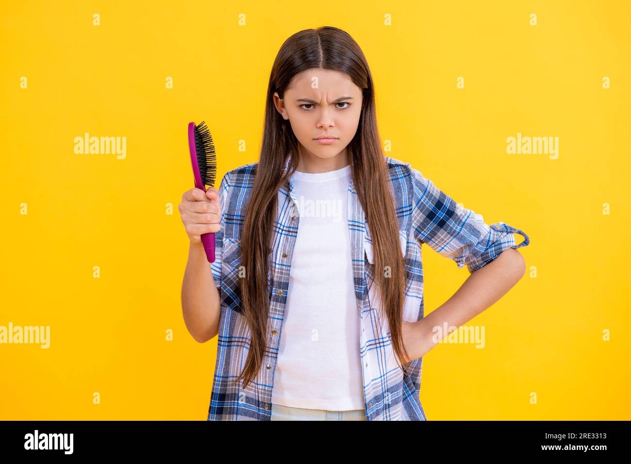 angry teen girl doing haircare in studio. haircare of teen girl with