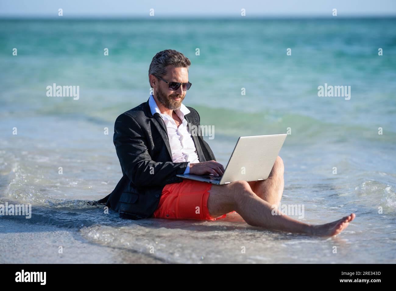 Summer business. Freelancer business man on summer vacation. weekend and remote freelance work. business man with laptop. Business man dreams on summe Stock Photo