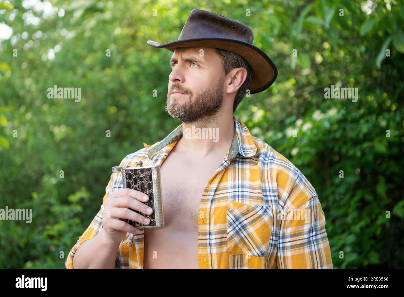 masculine cowboy thinking with flask. masculine cowboy with flask ...