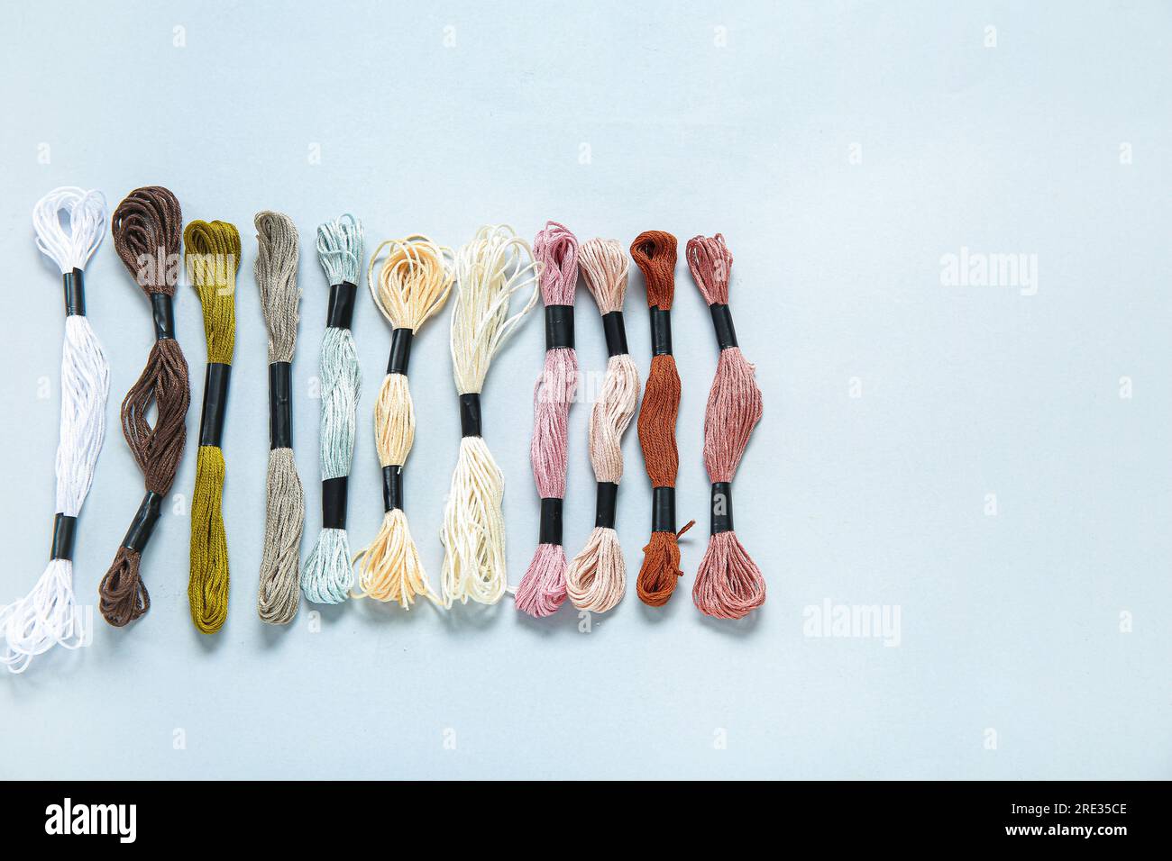 Different colorful mouline threads on white background Stock Photo - Alamy