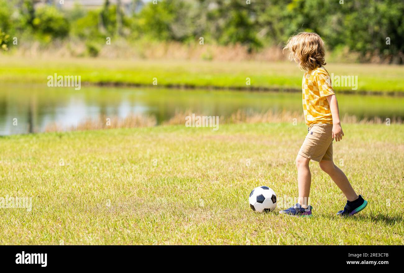 child enjoying childhood adventures outdoor. child playing football