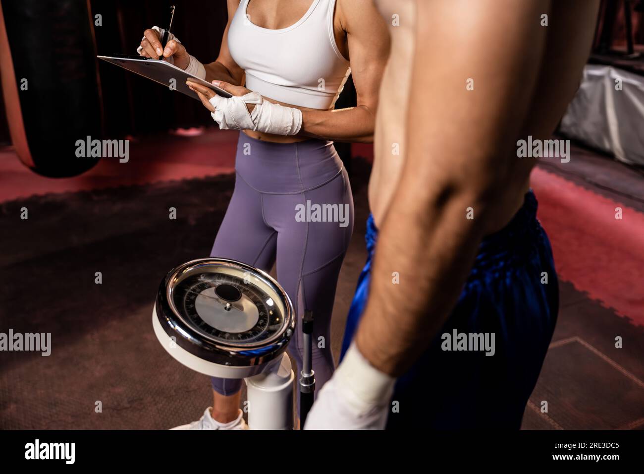 Boxer step on weight scale for boxing class designation by weight