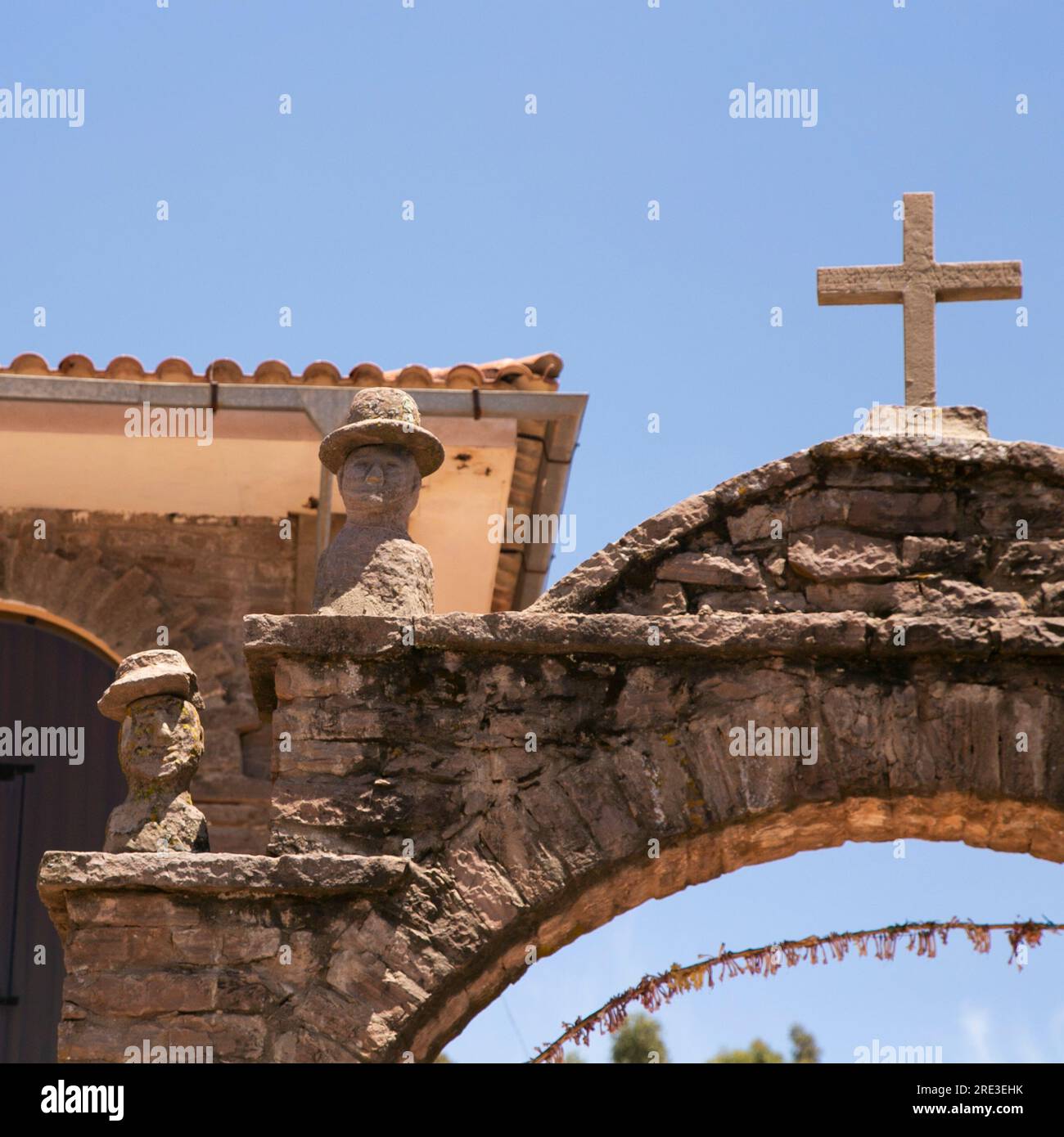 Stone heads carved into the arches on the island of Taquile on Lake Titicaca in Peru. Stock Photo