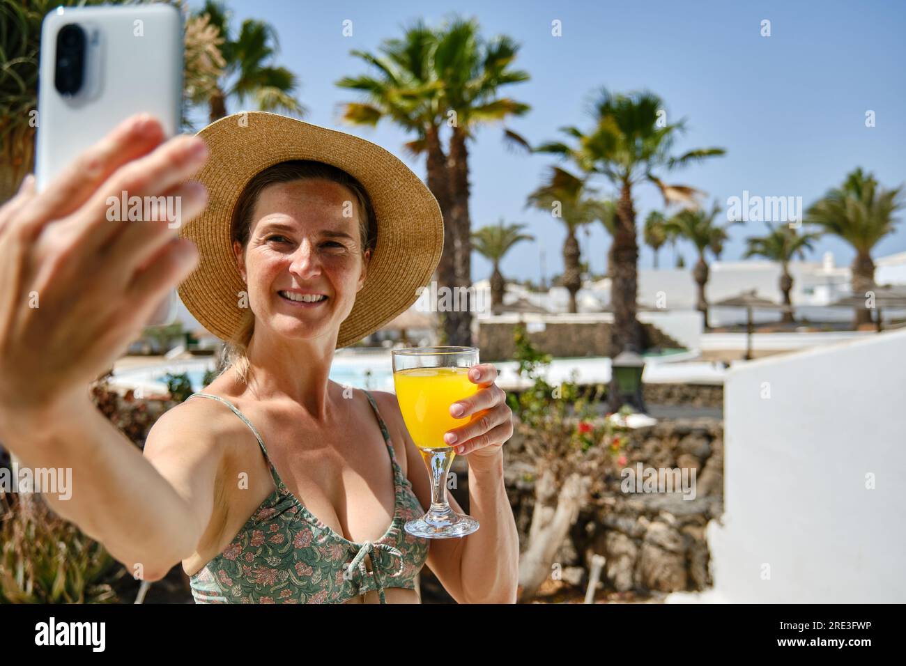 Cheerful woman in orange hat hi-res stock photography and images - Alamy