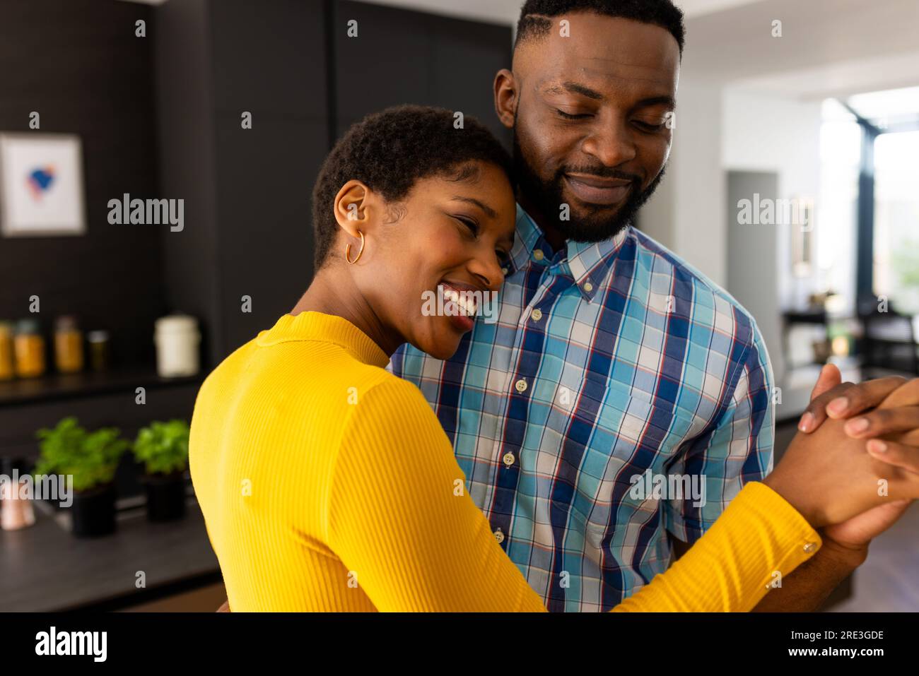 Happy african american couple dancing in kitchen at home Stock Photo ...