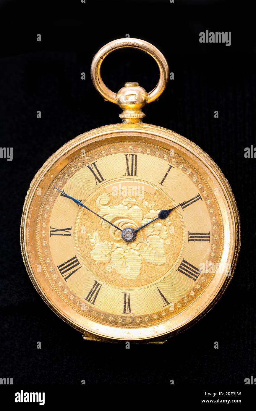 Vintage Swiss clockwork mechanism. Gold pocket watch on stone