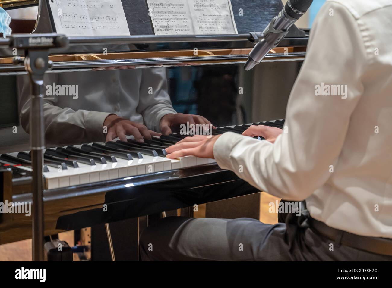 19.03.2021 Koblenz Germany - Male Hand playing on schimmel piano at party Event dinner Close-up Small depth of field. Stock Photo