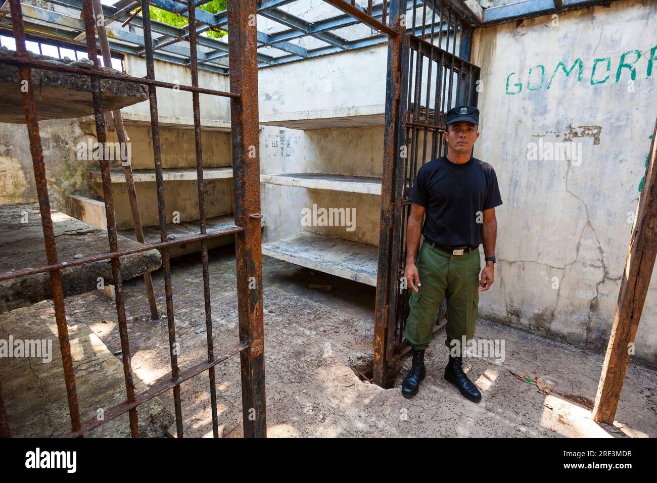 Police officer from the Panama police force outside a cell in the old prison at Coiba Island, Pacific coast, Veraguas Province, Republic of Panama. Stock Photo