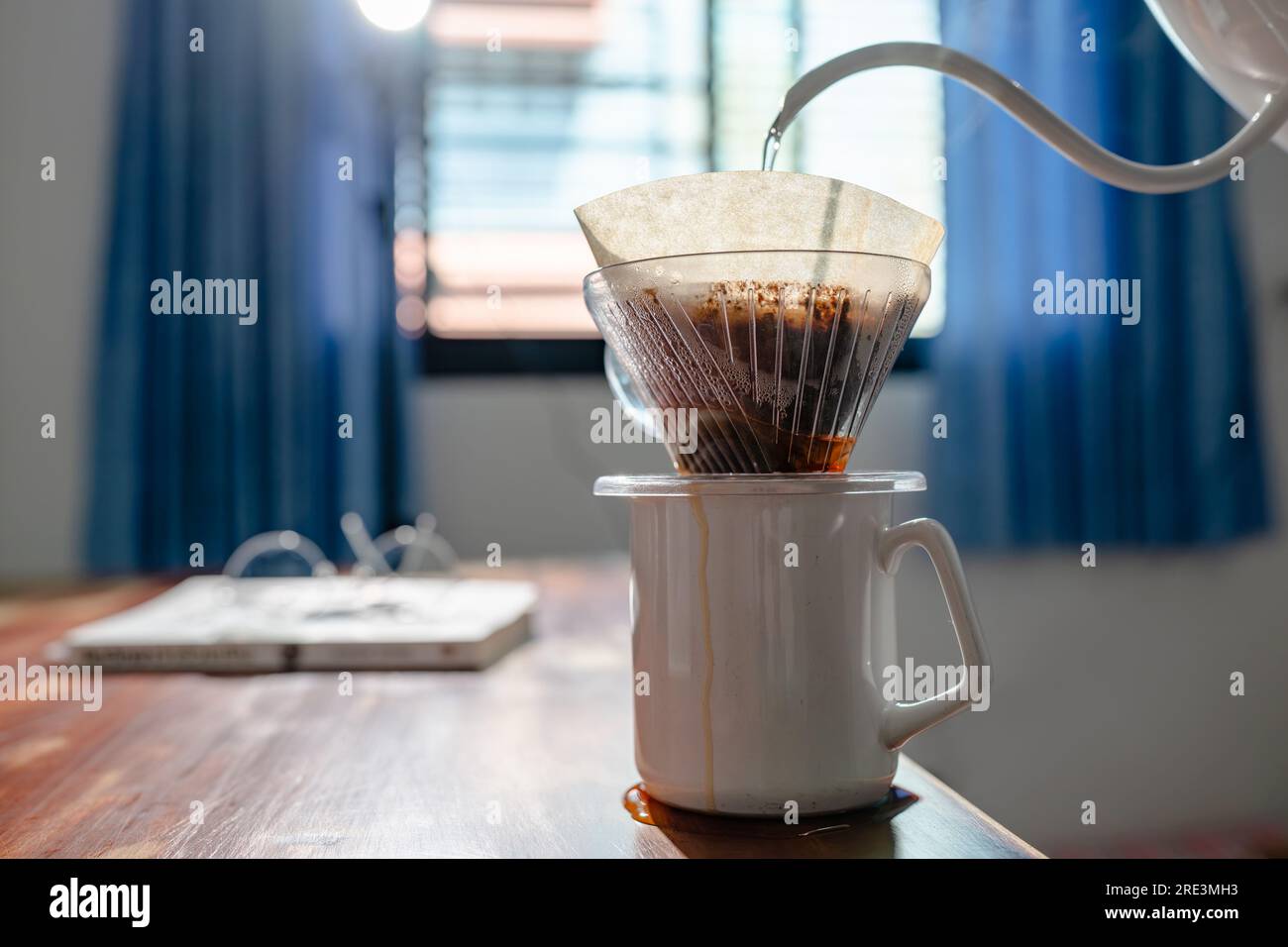 The coffee overflowed when poured too much water Stock Photo