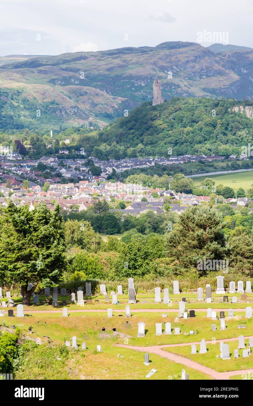 The Wallace Monument on Abbey Craig seen across the city from Stirling Castle, with Ochil Hills in the background and Old Town cemetery in foreground. Stock Photo