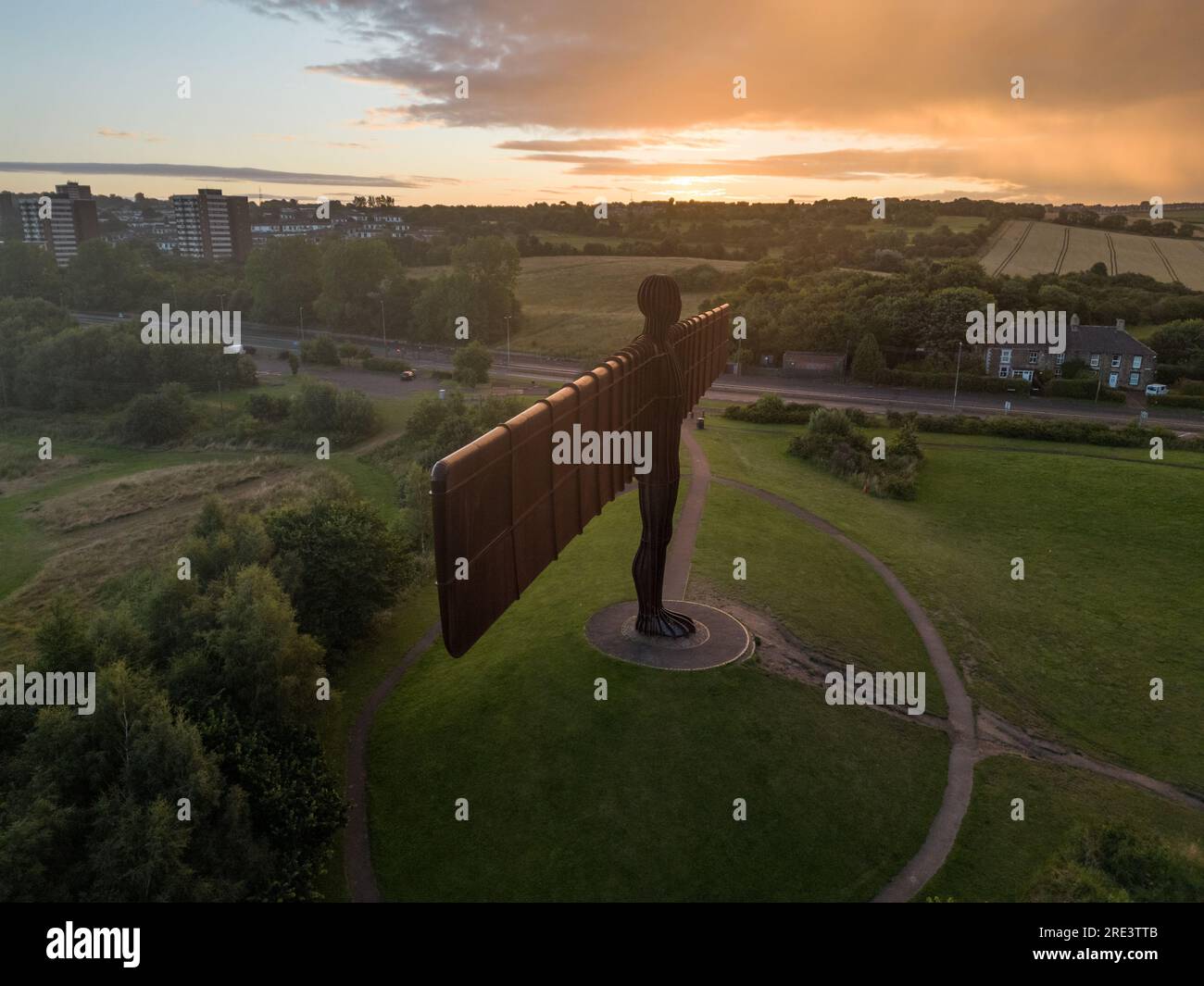 Side on drone shot of Angel of the North with sun rising on the wind tip Stock Photo