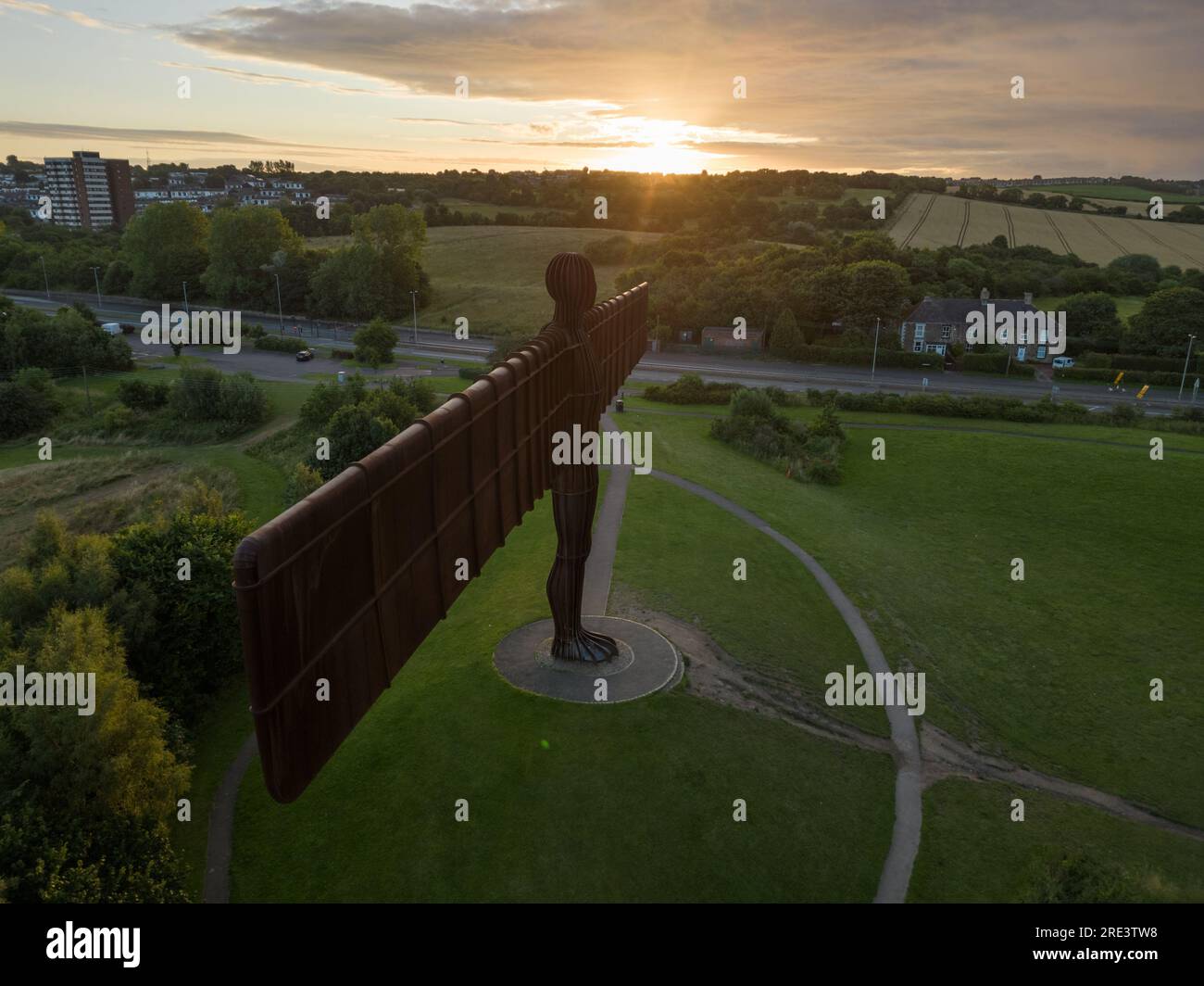 Side on drone shot of Angel of the North with sun rising on the wind tip Stock Photo