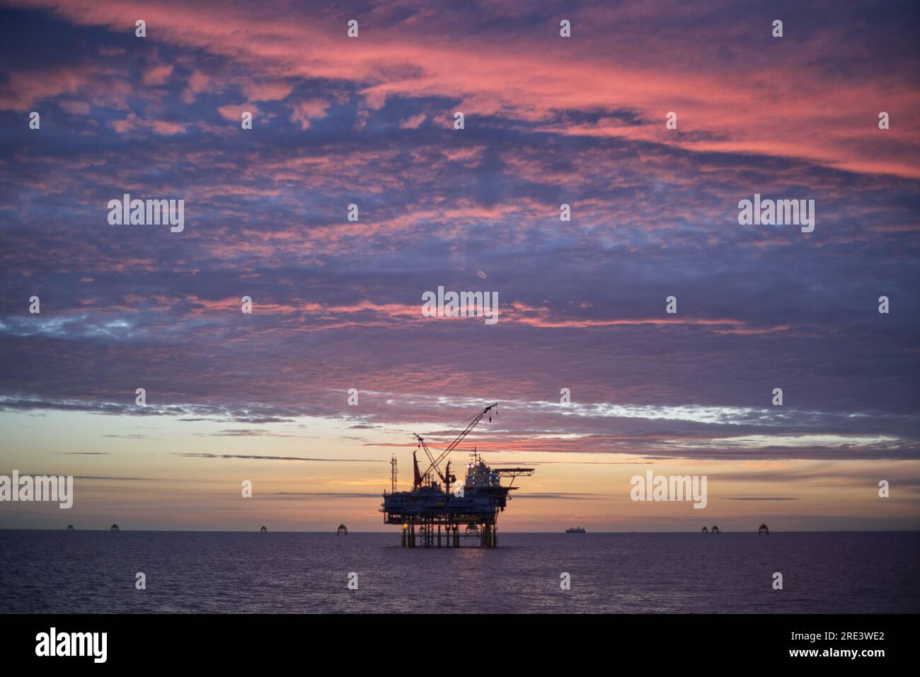 Jack up offshore platform in the sea at sunrise. Stock Photo