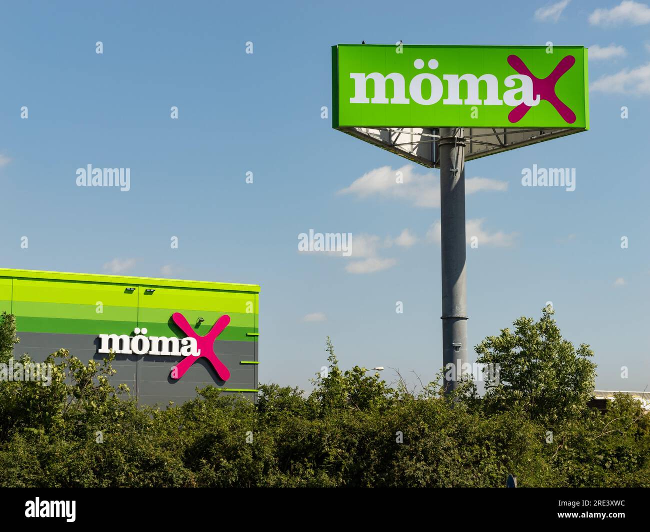 Mömax logo and sign as advertisement on the building exterior of the furniture store. The economical business is part of XXXLutz or the XXXL Group. Stock Photo