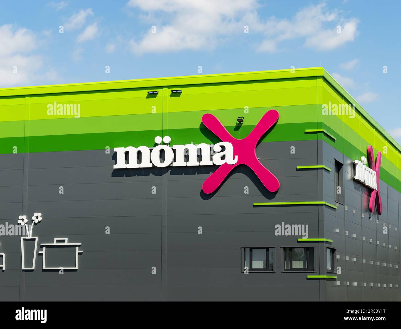 Mömax logo sign on the store building exterior. Furniture store with trendy products for a home improvement. Economic prices are a USP of the business Stock Photo