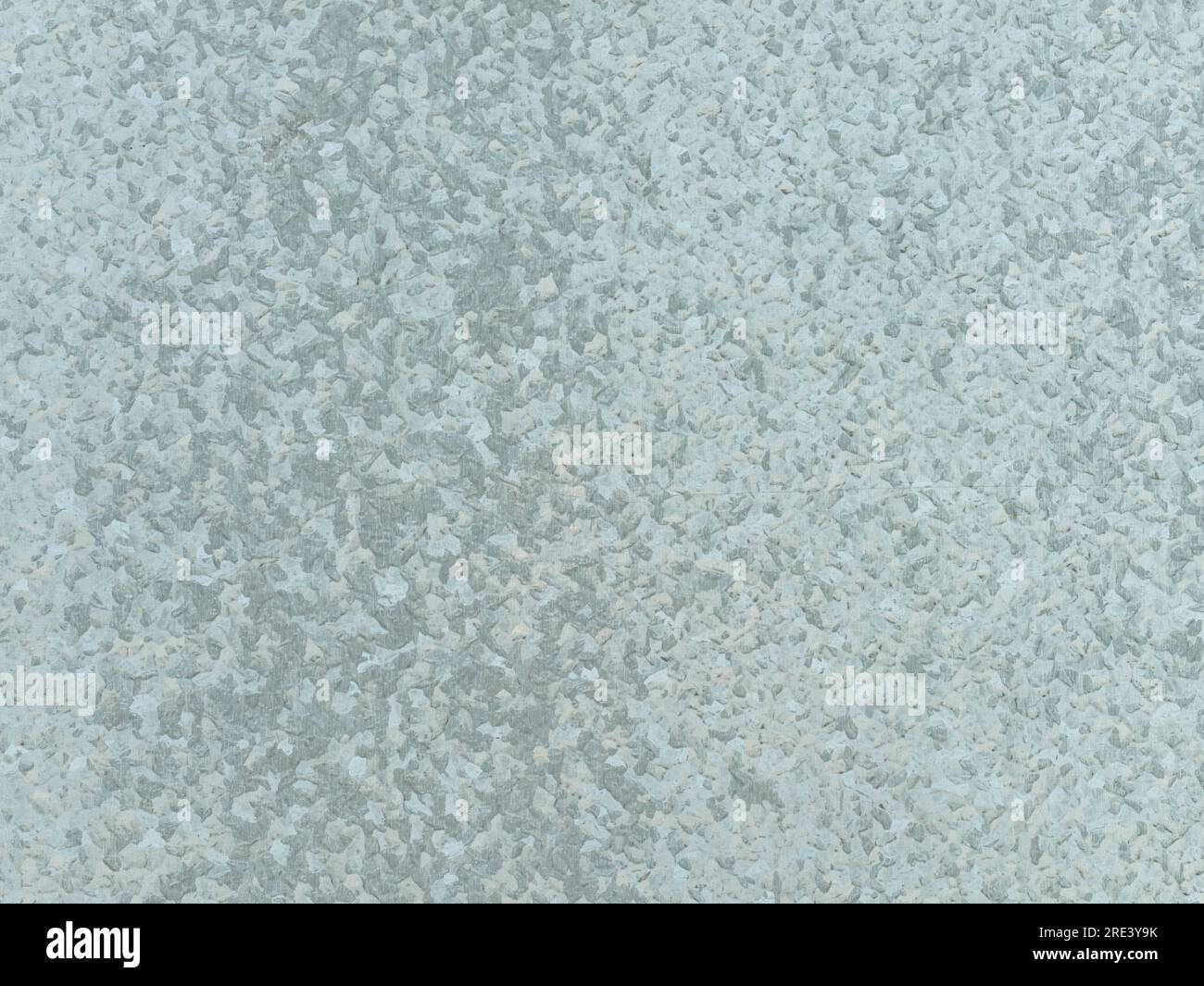 Zinc galvanized steel texture as background. The sheet metal is part of an fence in front of a building. The spangle is visible on the exterior. Stock Photo