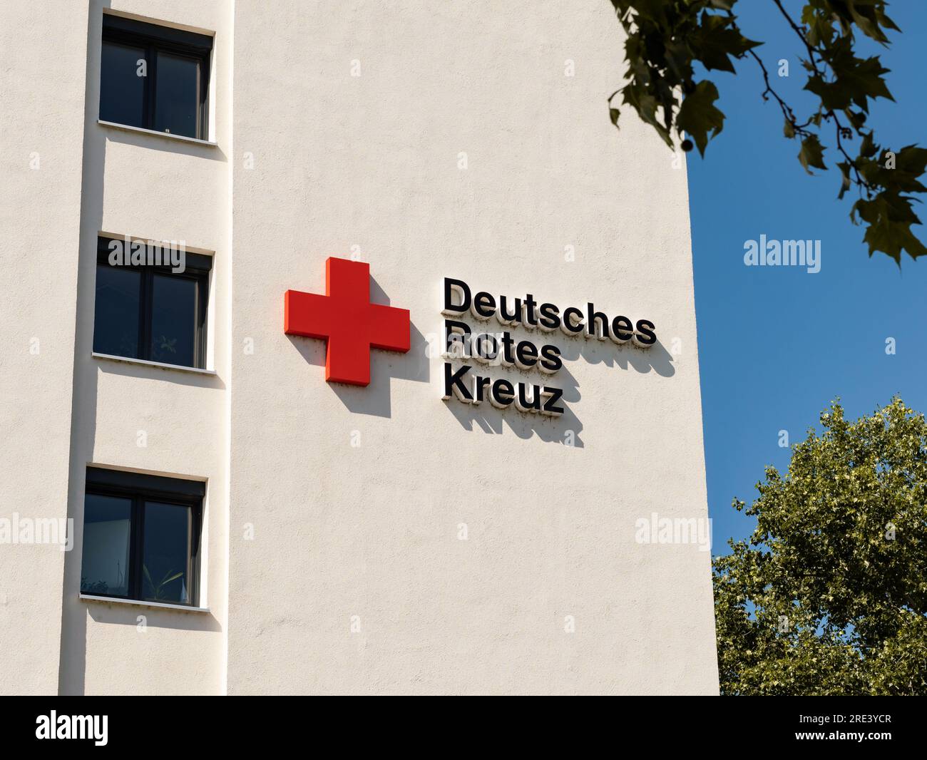 Deutsches Rotes Kreuz (German Red Cross) logo sign on a building exterior. The society offers health care services as a NGO in Germany. Stock Photo